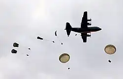 Soldiers from 3 RAR exit a C-130 Hercules aircraft during a parachute jump, 2005.