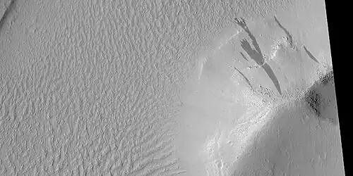 Dark slope streaks on mound in Lycus Sulci, as seen by HiRISE under HiWish program