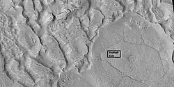 Ribbed terrain being formed from upper plains unit, as seen by HiRISE under HiWish program Formation begins with cracks that enhance sublimation. Box shows the size of football field.