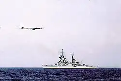 A Tu-95 Bear overflies a Sverdlov-class cruiser 1975