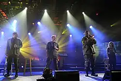 4TROOPS performing aboard the USS&nbsp;Intrepid in New York City during a taping of a PBS television special in 2010