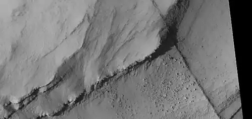 Close view of layers, as seen by HiRISE under HiWish program A ridge cuts across the layers at a right angle.