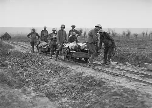5th Australian Field Ambulance Company soldiers evacuating wounded from the front near Ypres in trench railway hand cars.