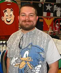 A white man with a short brown haircut and partial beard.