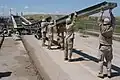 Soldiers (299 MRBC) steady the launch nose of a Medium Girder Bridge during erection over the Kazer River, Mosul, Iraq, 2003.