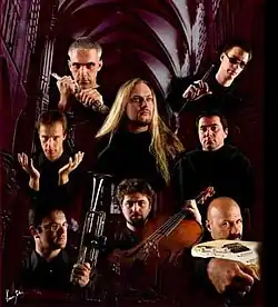 All artist stand together holding their instruments in a Cathedral setting