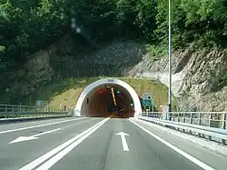 Road tunnel portal with variable traffic signs placed above the tunnel entrance