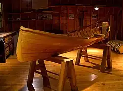 An Adirondack guideboat elevated on sawhorses