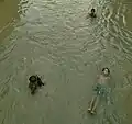 Children swimming in the pond