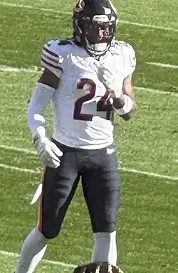 Football safety Adrian Colbert walking on the field in a Chicago Bears jersey, with "24", his number, on the front of it. He is also wearing a black Bears helmet as well.