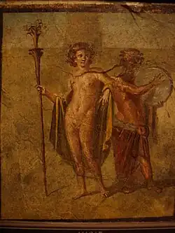 Painting of two people - the figure on the left holds a staff, while the one on the right plays a tambourine.