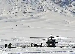 Afghan Local Police and coalition special operations forces load a police member needing medical care onto an MH-60 Black Hawk helicopter during a medical evacuation in January 2012