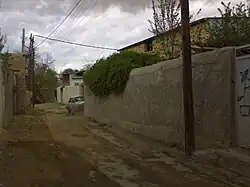 An empty alleyway under an overcast sky