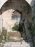 You can find a spring water outlet below ground level.