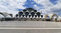 In Front of Al-Jabbar Grand Mosque facade, December 2025