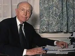 head and shoulders image of clean shaven, slim, bald man of mature years; the same man in the picture at the head of the page