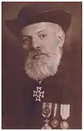 Alexandru Munteanu wearing an Officer's cross, civilian version.