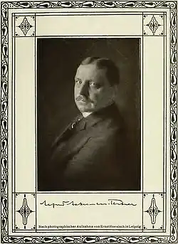 a black and white photo of a man in a suit looking at the camera