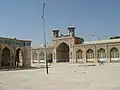 The mosque sahn, iwan, and minarets