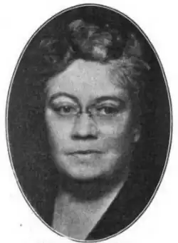 Black-and-white photograph of a woman looking at the camera