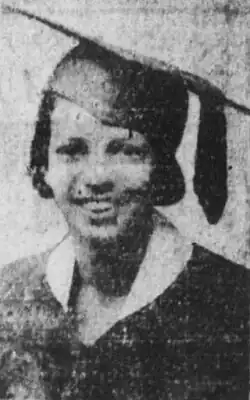 A smiling young Black woman with light skin
