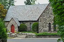 Stone English Gothic–style church with red door