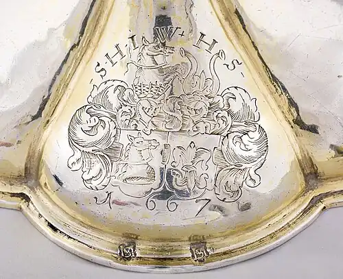 The arms of alliance of Vind and Skinkel on the foot of the challice in Sønder Nærå Church.