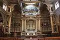 High altar, with altar rails and steps to the pulpit on the left.