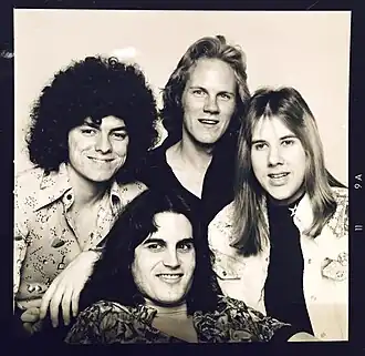 Founding Members of Ambrosia in 1975 From left to right: Joe Puerta, Burleigh Drummond, David Pack. Bottom: Christopher North