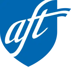 The lowercase letters A F T set in cursive script inside a blue shield shape.