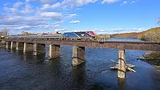 A train on a bridge crossing a wide river