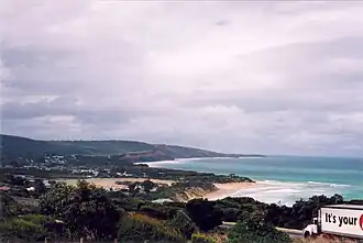 Anglesea, including the tidal river mouth, seen from the Loveridge Lookout above the Great Ocean Road, 2004. In the middle ground is the main beach, home to the Anglesea Surf Life Saving Club, with Point Addis in the far distance.