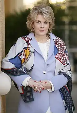 Finucane looking at a camera while holding her hands