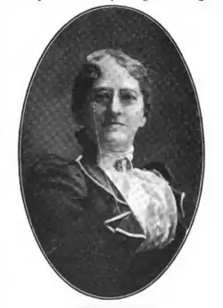 B&W portrait photo of a middle-aged woman with her hair in an up-do.