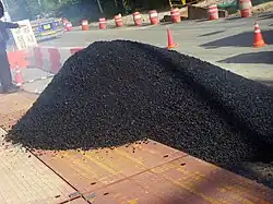 Image 2Pile of asphalt-covered aggregate for formation into asphalt concrete (from Oil refinery)