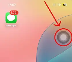 AssistiveTouch floating button on the edge of an iPhone screen, indicated by a red arrow and circle.