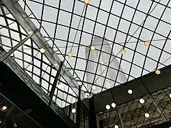 Photograph of a cage-like lattice, looking up toward the tower heights