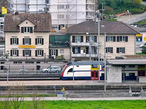 White train at island platform
