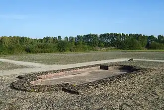 Color photograph of a rectangular ancient basin with rounded ends.