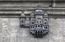 A birdhouse on the mosque wall.