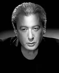 black-and-white close-up of Alain Bashung wearing a dark shirt, looking intently just right of camera