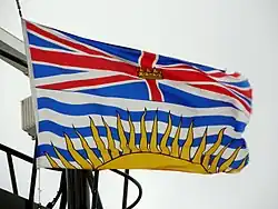 Flag of British Columbia showing a Union Flag, defaced with a gold crown, in the upper division