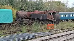 Photograph showing a railway locomotive in scrapyard condition at Horsted Keynes station.