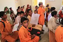 Children sitting and standing in a room