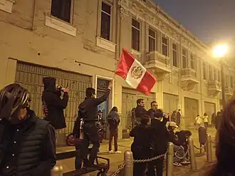 Peruvian protester waving the flag