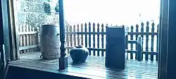 A banggéra at Casa Manila, here used as a display shelf for two tapáyan jars (one with a faucet) and a mill.