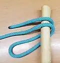 wrap the bight around the pole and under the rope.