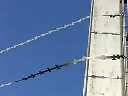 Barbed tape on a fence