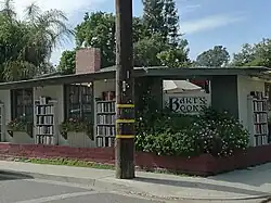 A front view of the bookstore. Bookshelves are in front of the building's walls.