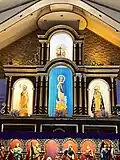 The cathedral's main retablo bearing the images of The Holy Trinity, St. Joseph, Our Lady of the Immaculate Conception of Batanes, and St. Dominic de Guzman.